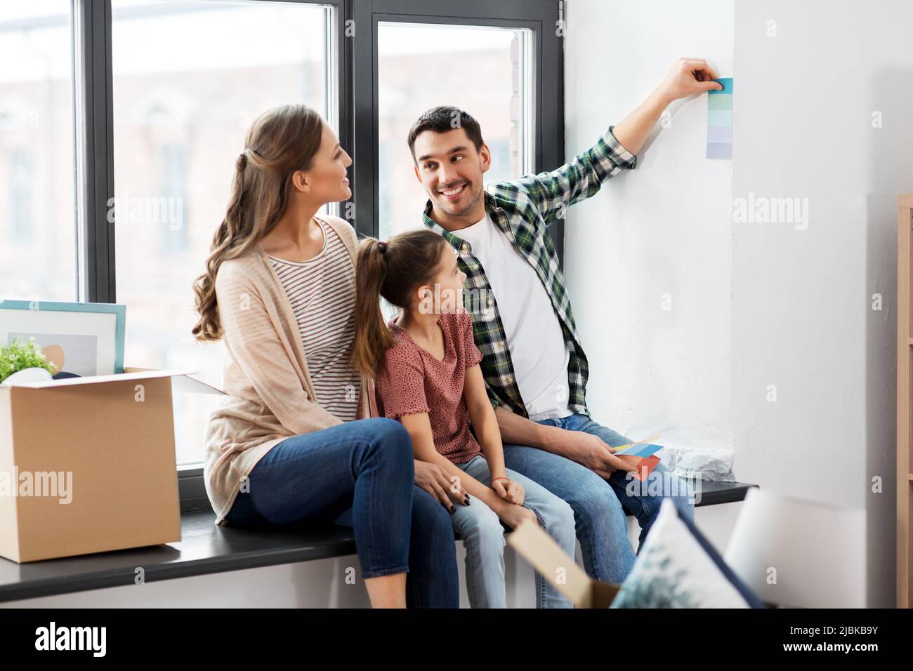 happy family with color palette moving to new home Stock Photo