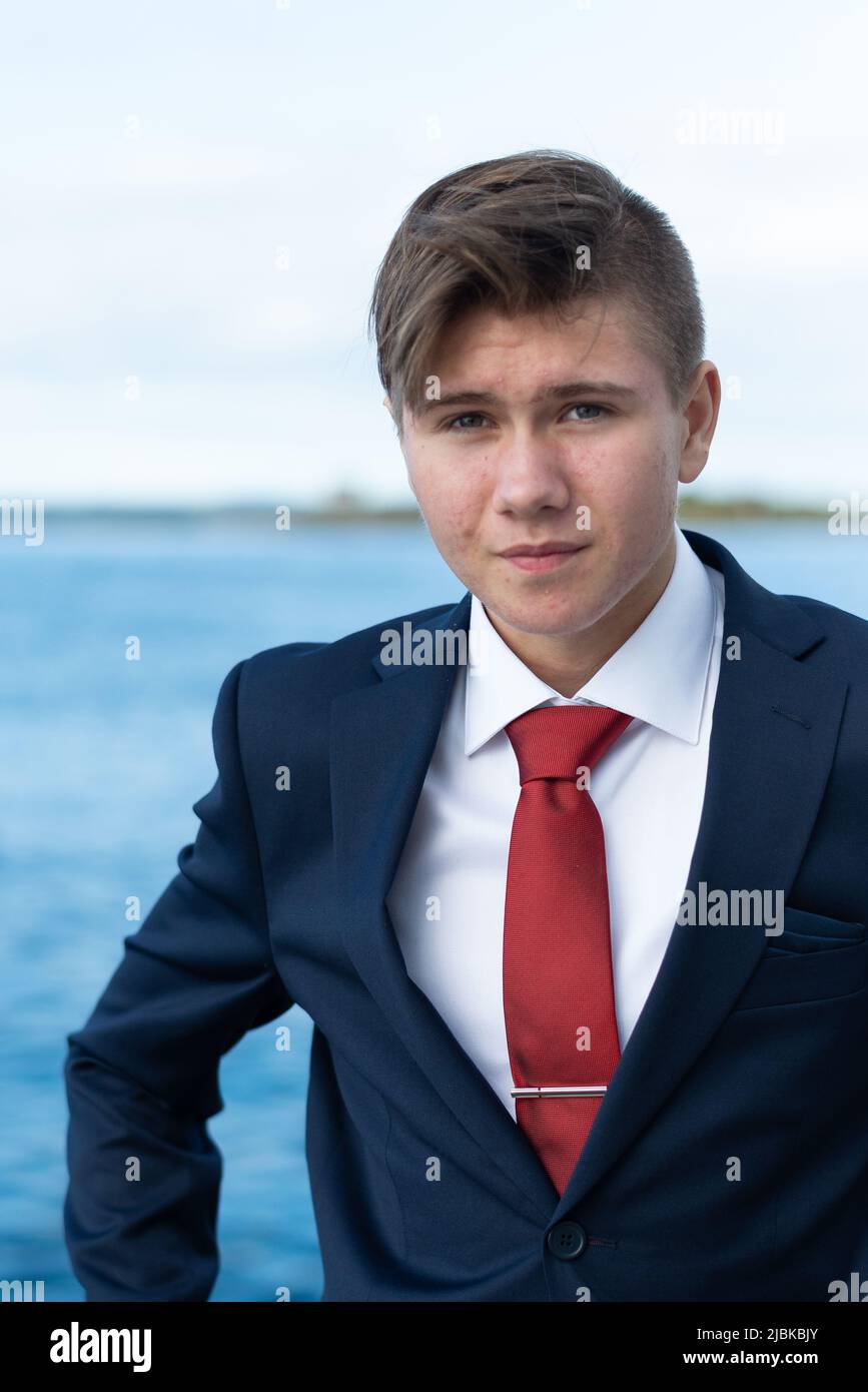 A dressed up young man looking direct in the camera in a sincere way, seeminly calm, safe and self-assured. Stock Photo