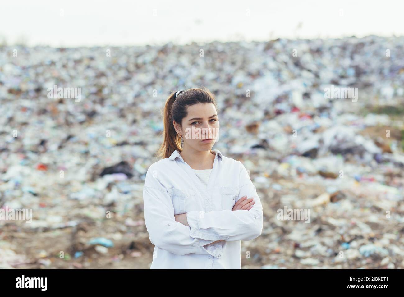 Angry woman standing in a landfill, dissatisfied with the scale of ...