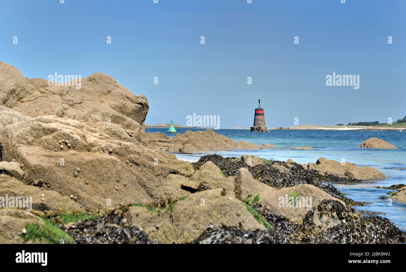 rocky beach  view with beacon  background in aber Benoit, Brittany- France Stock Photo
