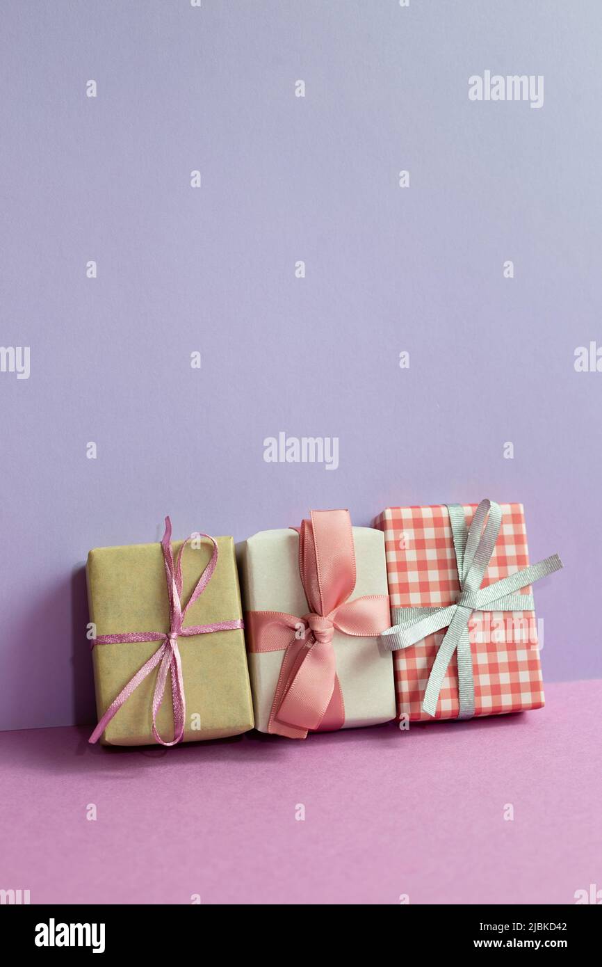 Gift boxes on purple table. purple wall background. copy space Stock Photo