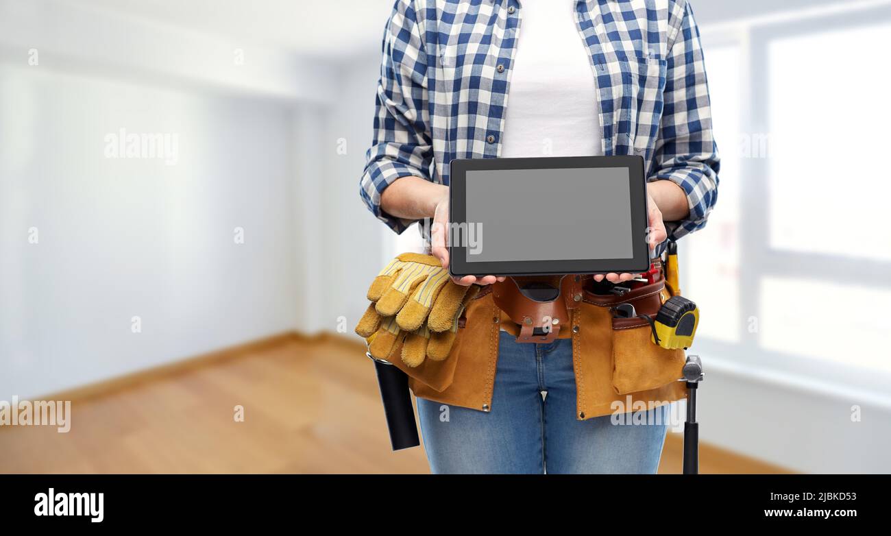 woman builder with working tools showing tablet pc Stock Photo