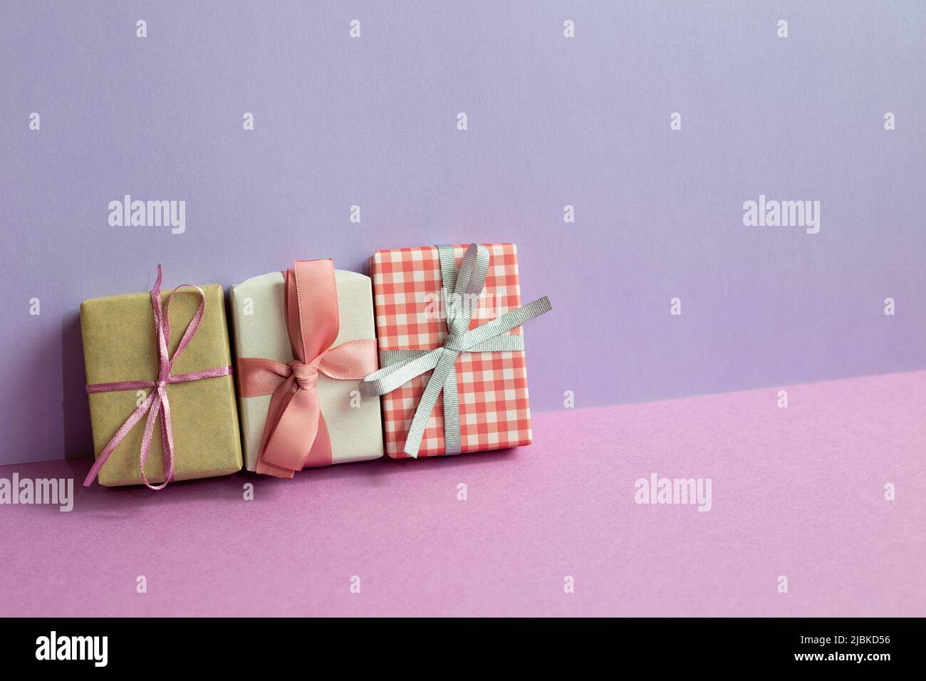 Gift boxes on purple table. purple wall background. copy space Stock Photo