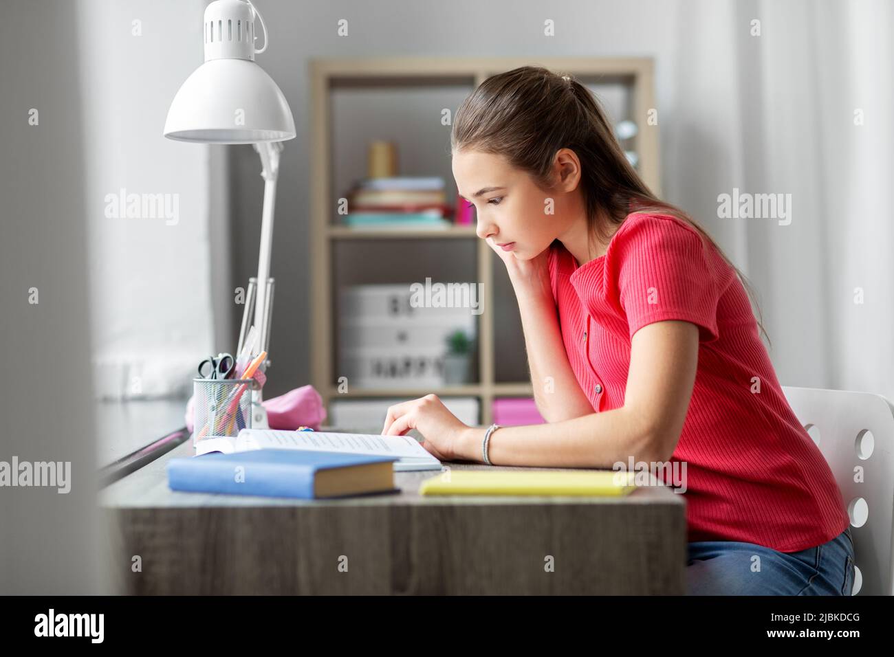 student teenage girl reading book at home Stock Photo - Alamy
