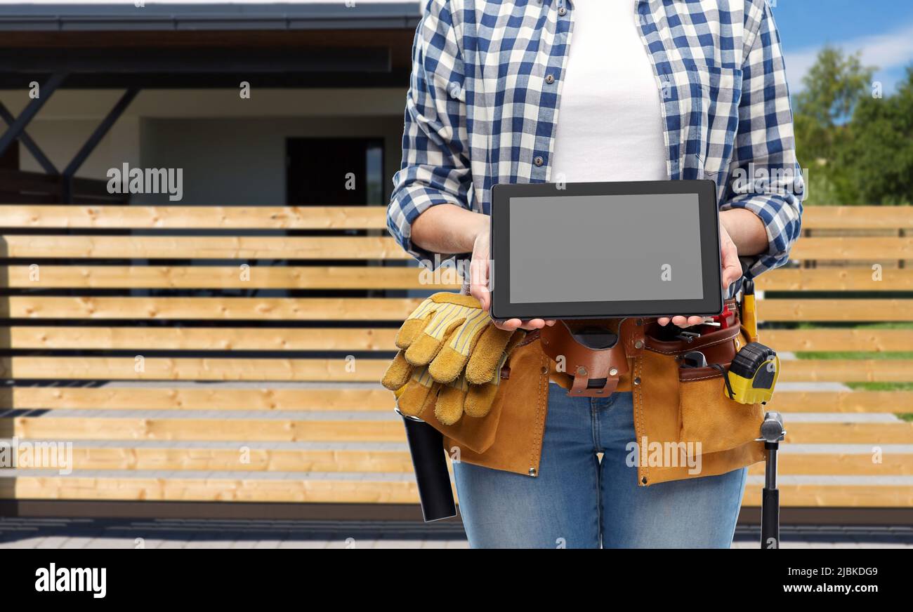 woman builder with working tools showing tablet pc Stock Photo