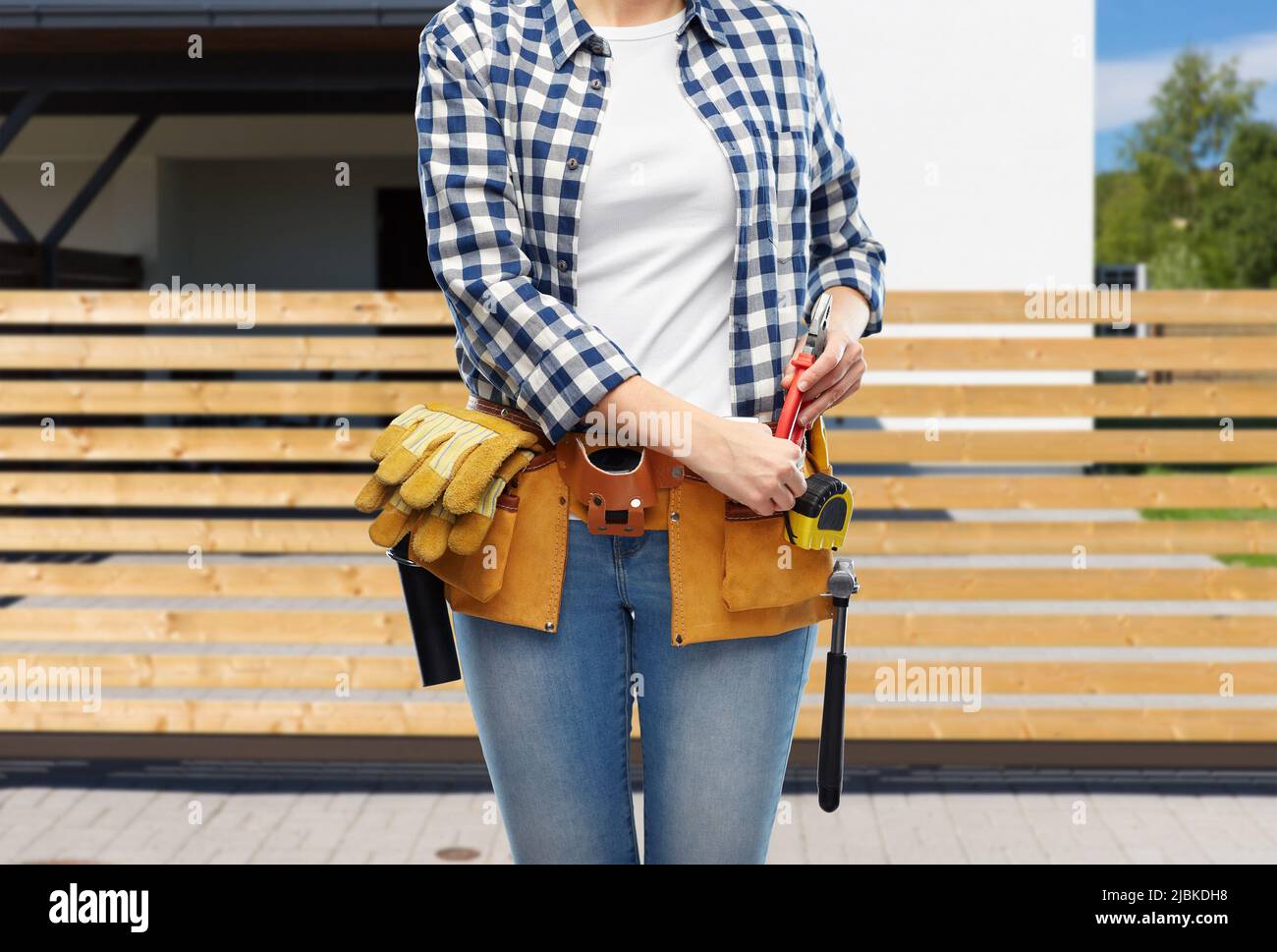woman or builder with working tools on belt Stock Photo