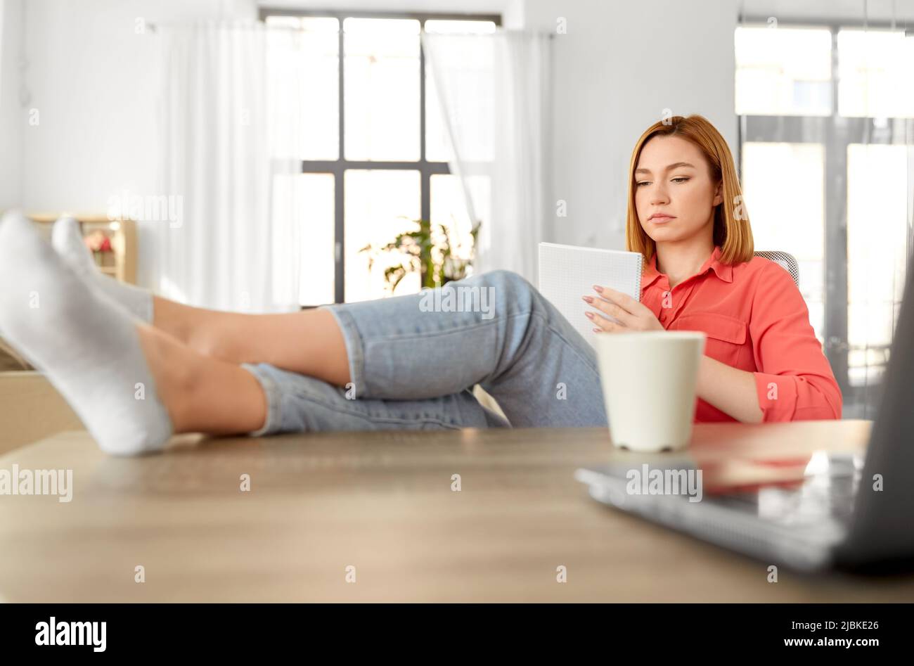 woman with notebook and laptop at home office Stock Photo