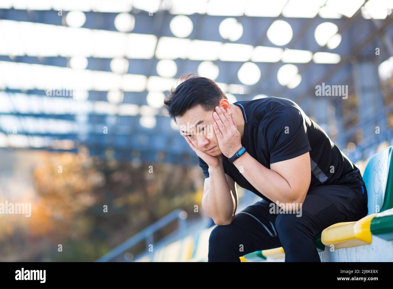 Frustrated Asian male athlete depressed, dissatisfied with the result