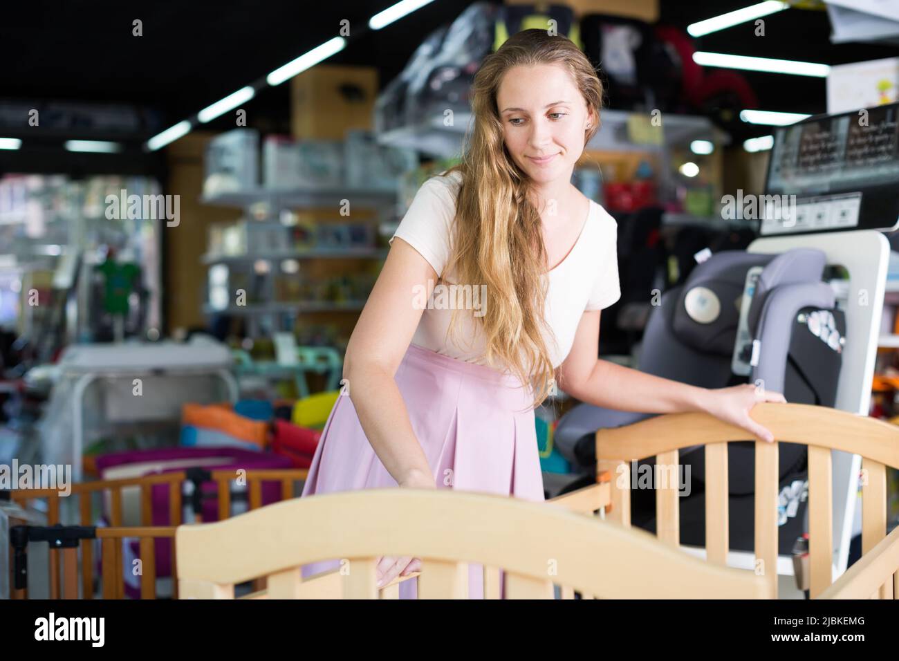 pregnant female buying baby crib Stock Photo Alamy