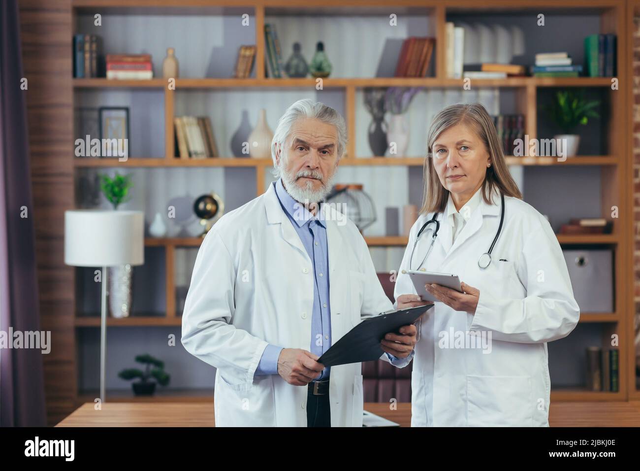 Grayhaired fellow doctors, male and female doctors work together in a