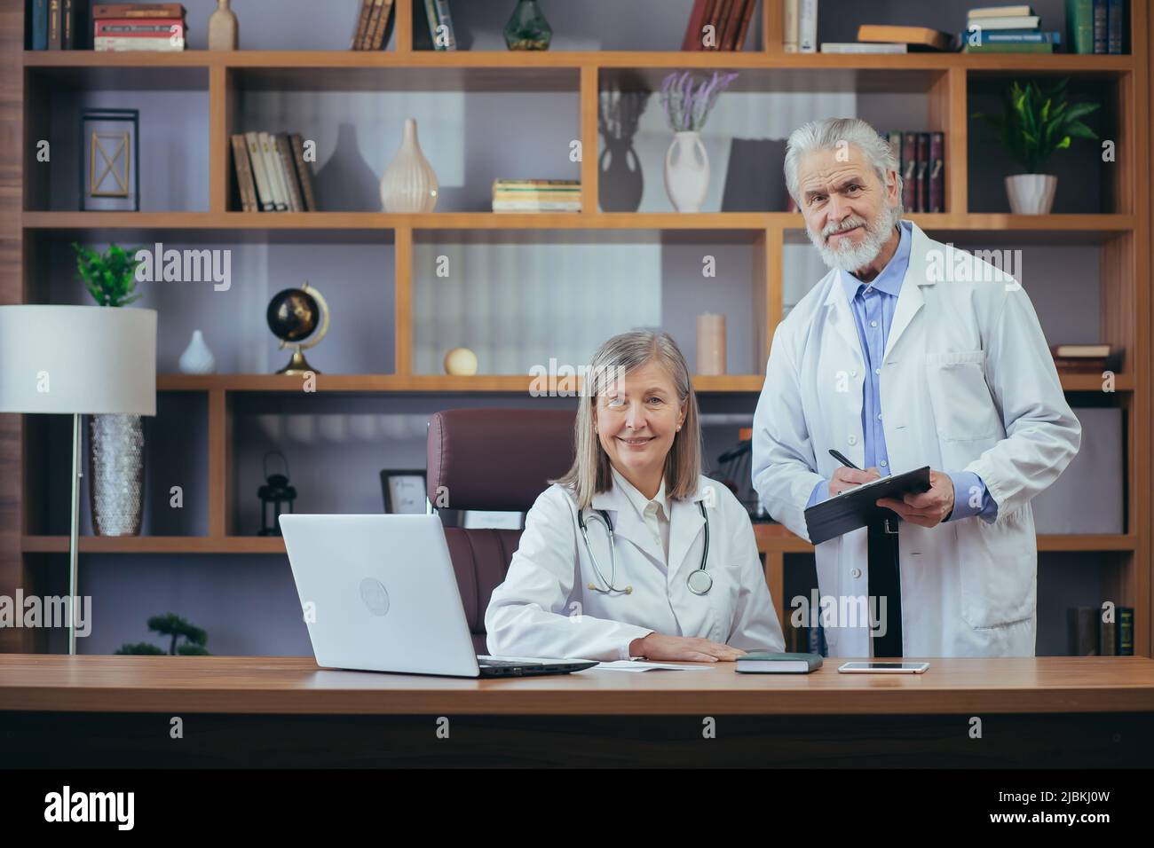 Grayhaired fellow doctors, male and female doctors work together in a