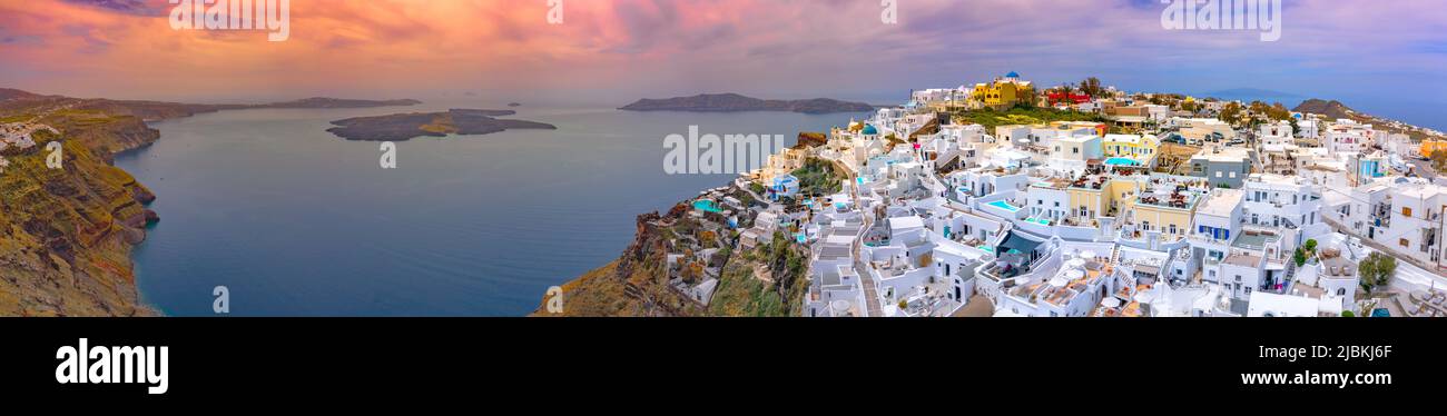 Oia town on Santorini island, Greece. Traditional and famous houses and churches with blue domes over the Caldera, Aegean sea Stock Photo