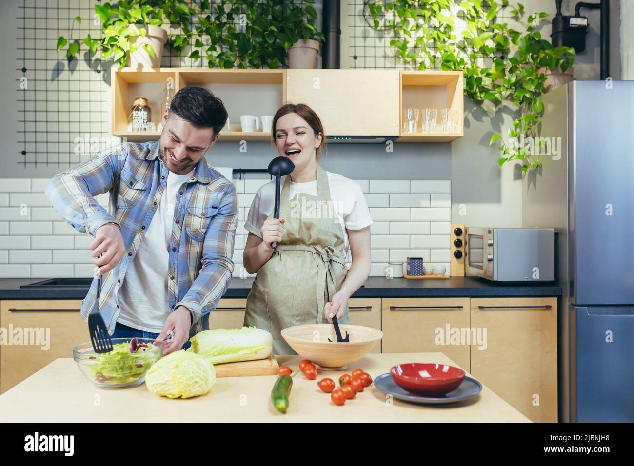 Man and woman in a kitchen, husband helping prepare a healthy meal