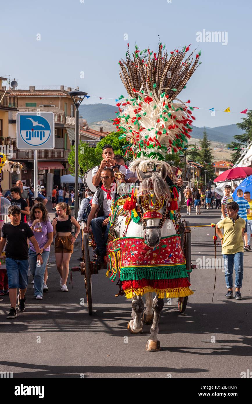 Traditional Sicilian folk musicians with their gaily decorated horse and cart, at the annual strawberry festival in Maletto, Sicily, Italy Stock Photo