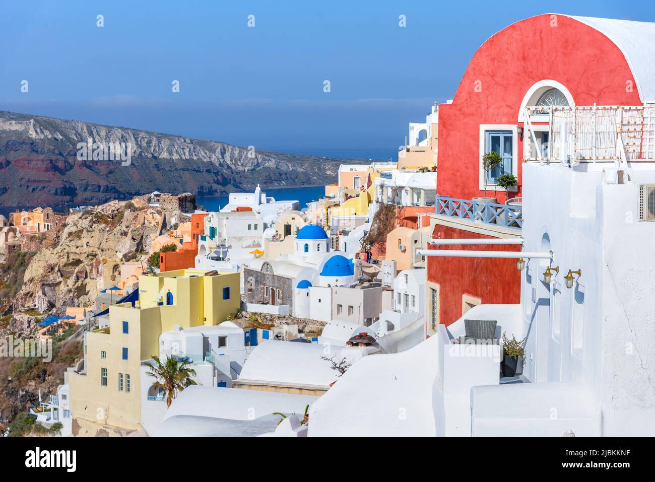 Oia town on Santorini island, Greece. Traditional and famous houses and churches with blue domes over the Caldera, Aegean sea Stock Photo