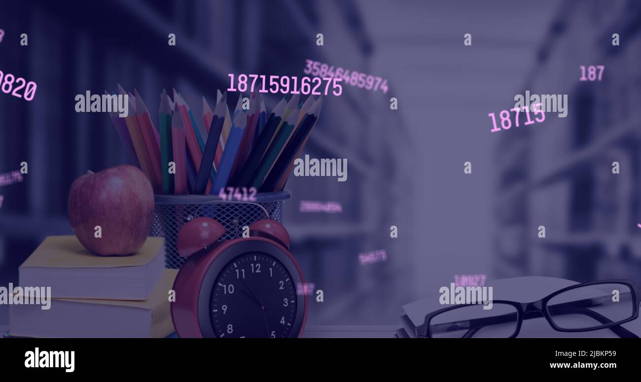 Image of growing numbers over school items in class Stock Photo