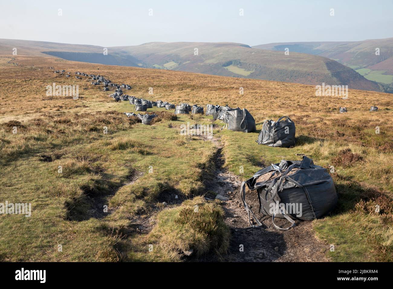 Bags of rocks and gravel delivered by helicopter for footpath repair work, head of the Grwyne Fawr in the Black Mountains, Brecon Beacons National Par Stock Photo