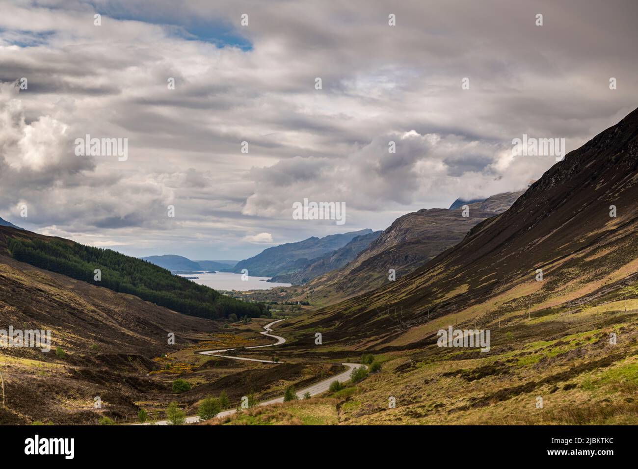 A cloudy, summer, HDR landscape image looking down Glen Docherty to Loch Maree in Wester Ross, Scotland. 23 May 2022 Stock Photo