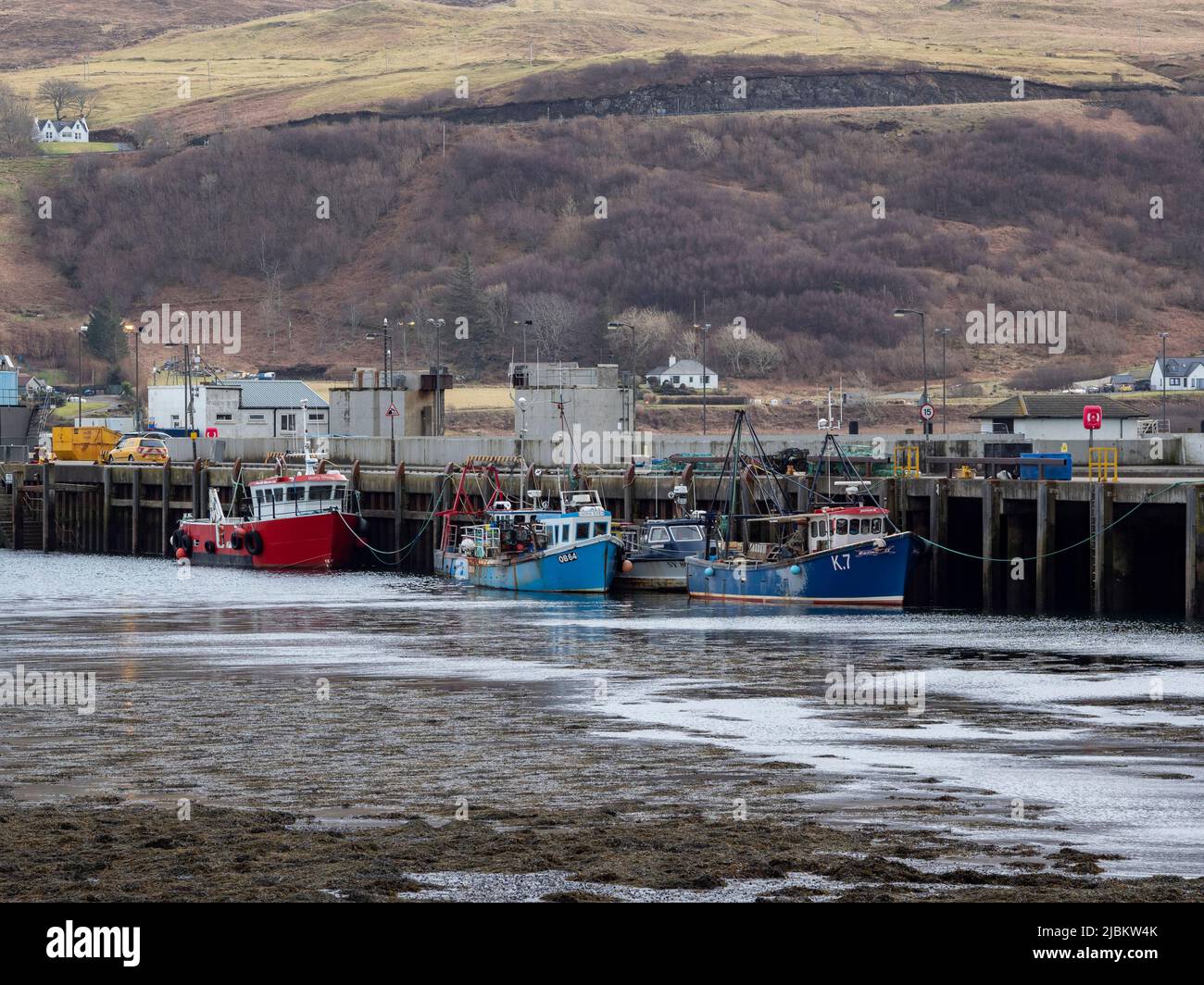 Fishing boats moored at Uig pier on the Isle of Skye, Scotland Stock Photo