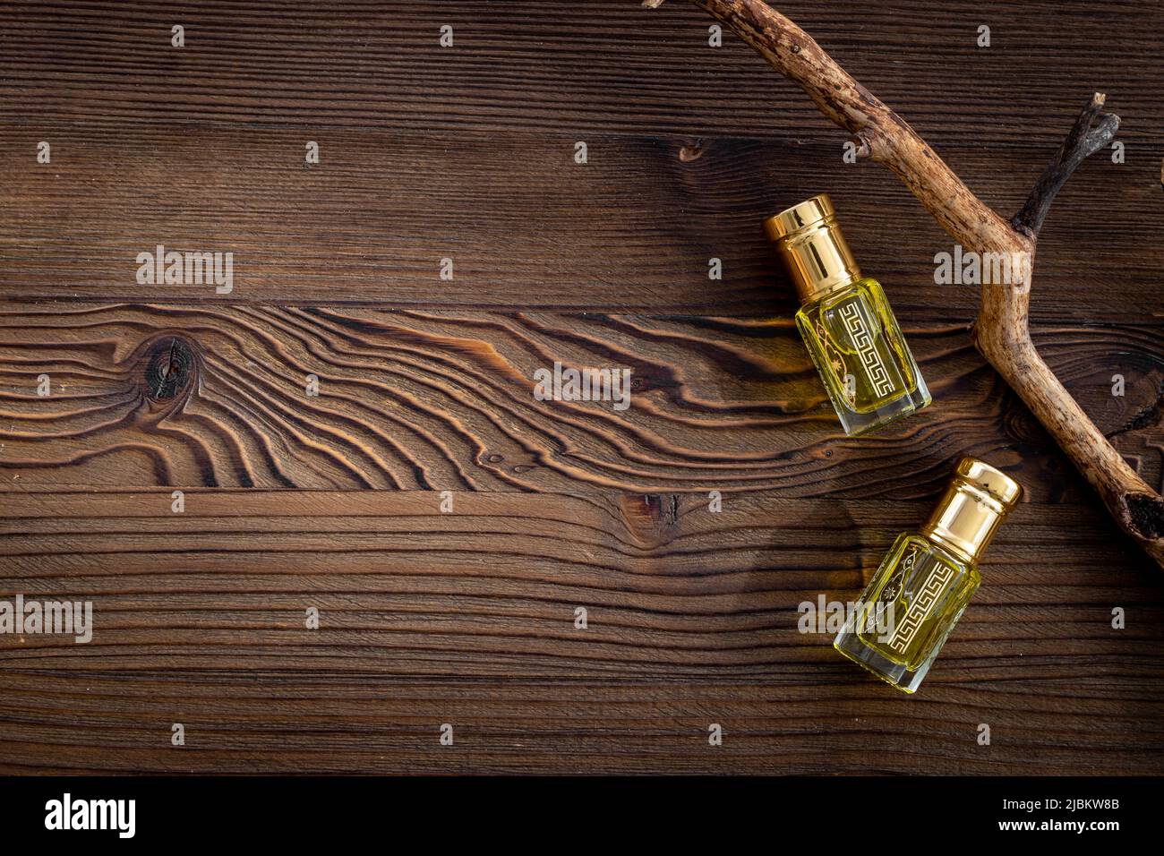 Arabian oud attar perfume essential oil in glass bottles, top view