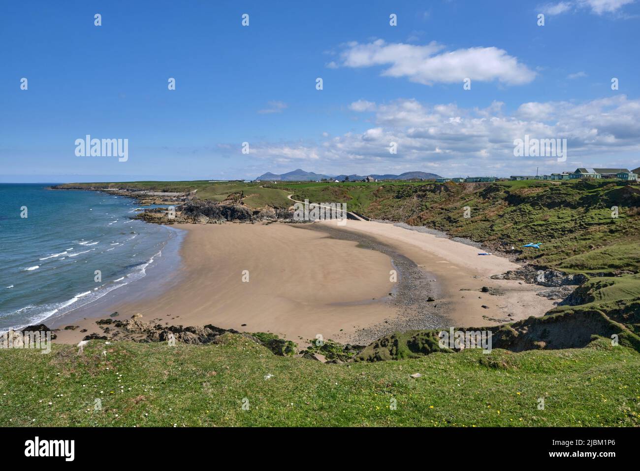 A view across Porth Towyn beach on the Llyn Peninsula from the Wales Coast Path looking towards Yr Eifl Stock Photo