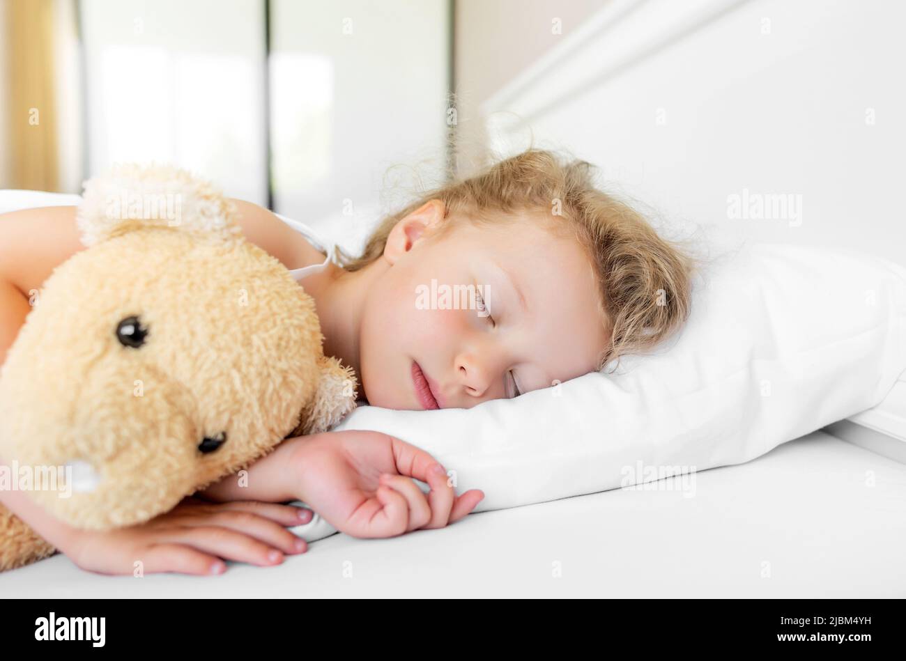 The child sleeps in his bed Stock Photo Alamy