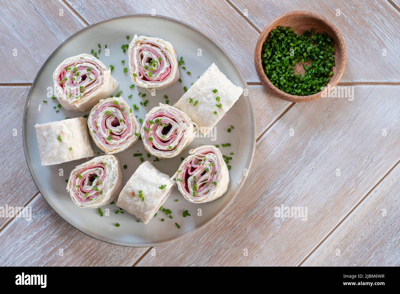 Ham and cream cheese rolled up in a flour tortilla Stock Photo