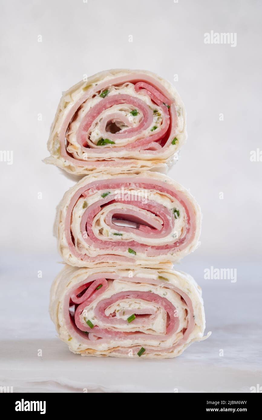 Ham and cream cheese rolled up in a flour tortilla Stock Photo
