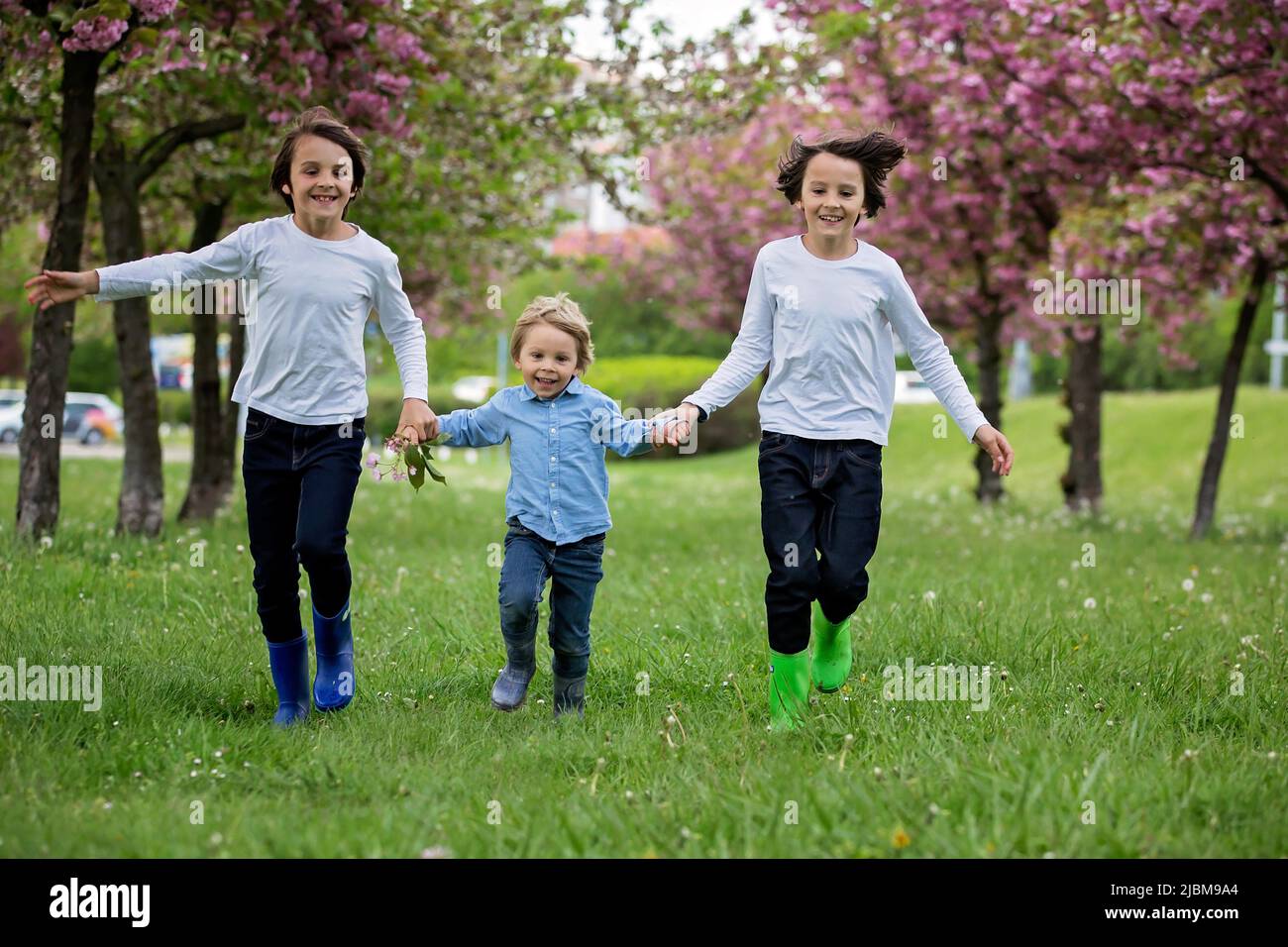 Happy children of different age groups, running together in the park