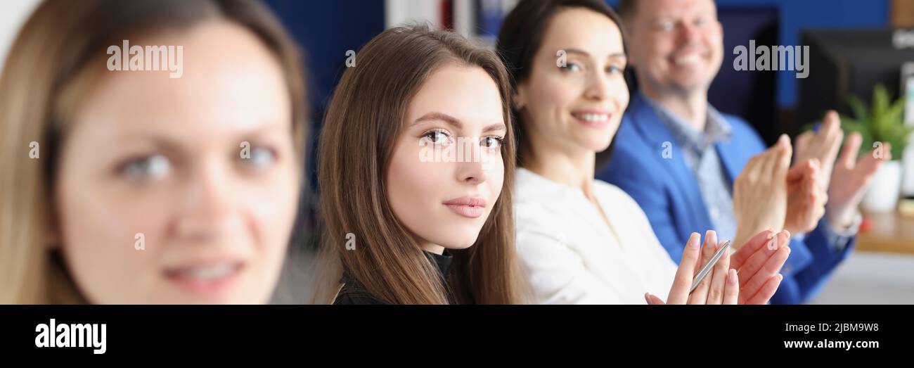 Workers in presentable suits sit in room Stock Photo