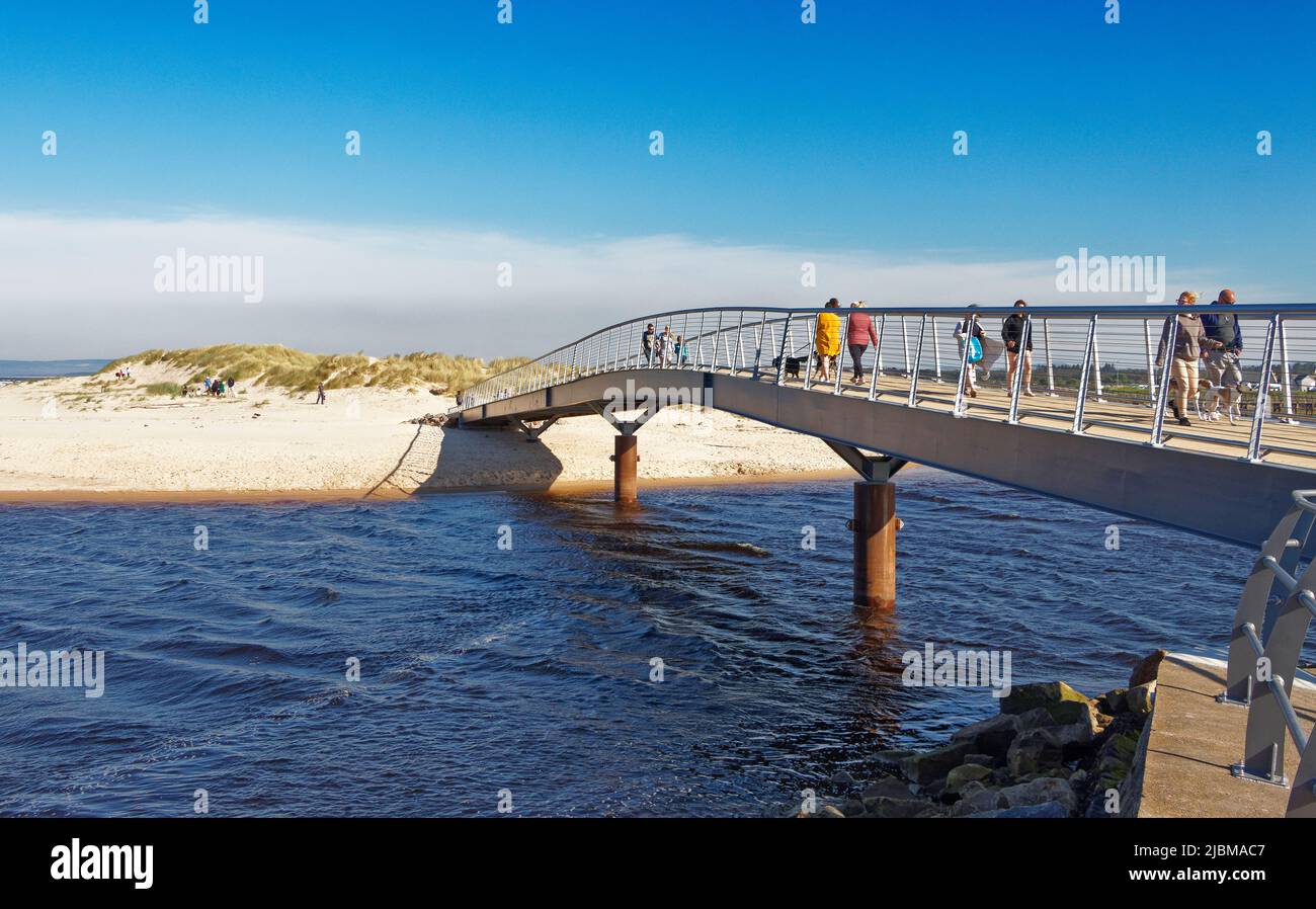 LOSSIEMOUTH MORAY SCOTLAND PEOPLE CROSSING THE NEW BRIDGE OVER THE RIVER LOSSIE TO EAST BEACH Stock Photo