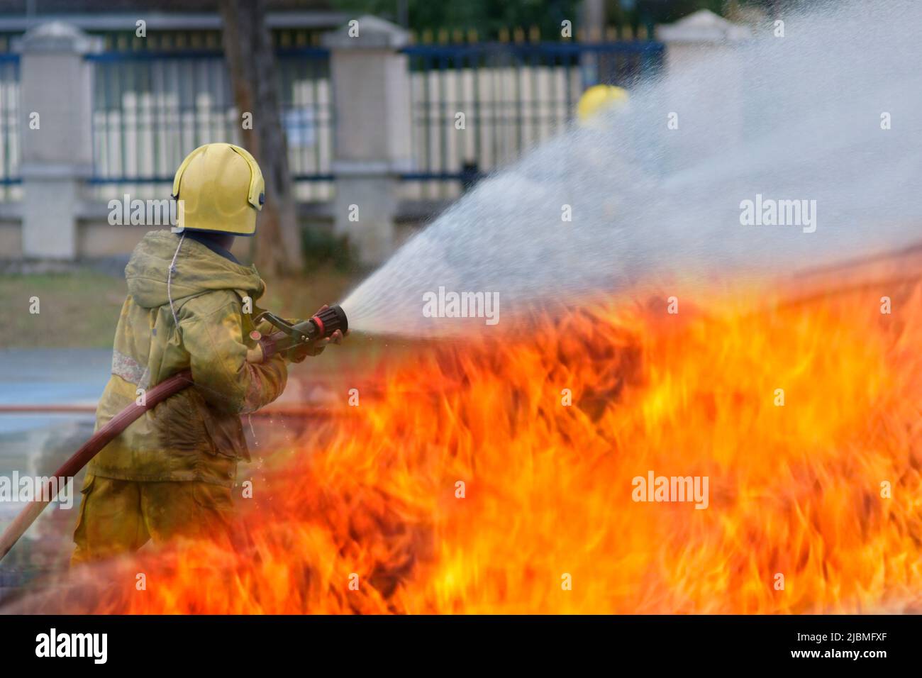 fire fighter Using water mist fire extinguishers to combat oil flames
