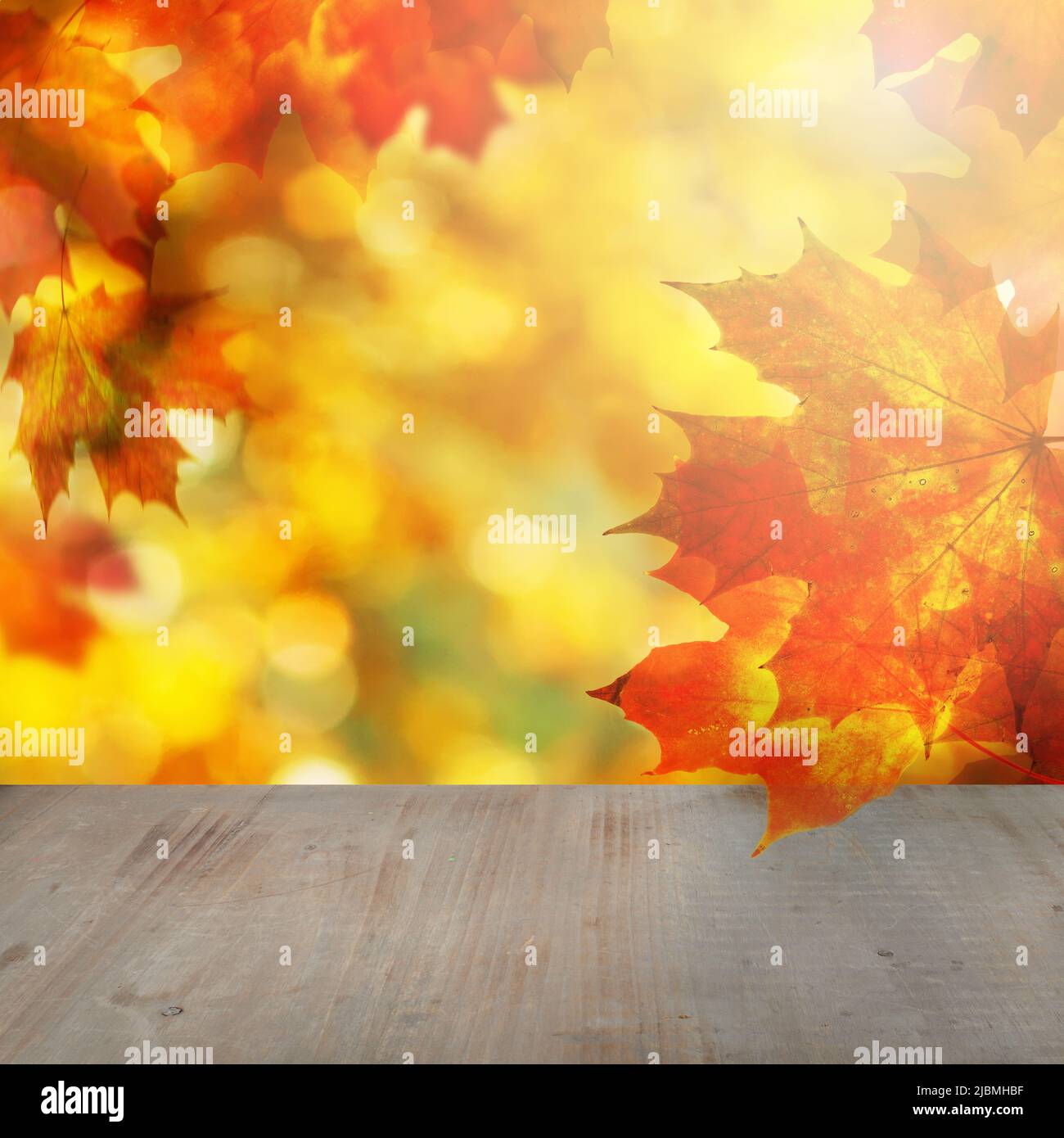 Abstract bokeh glitter, autumn maple leaves and empty wooden table ...