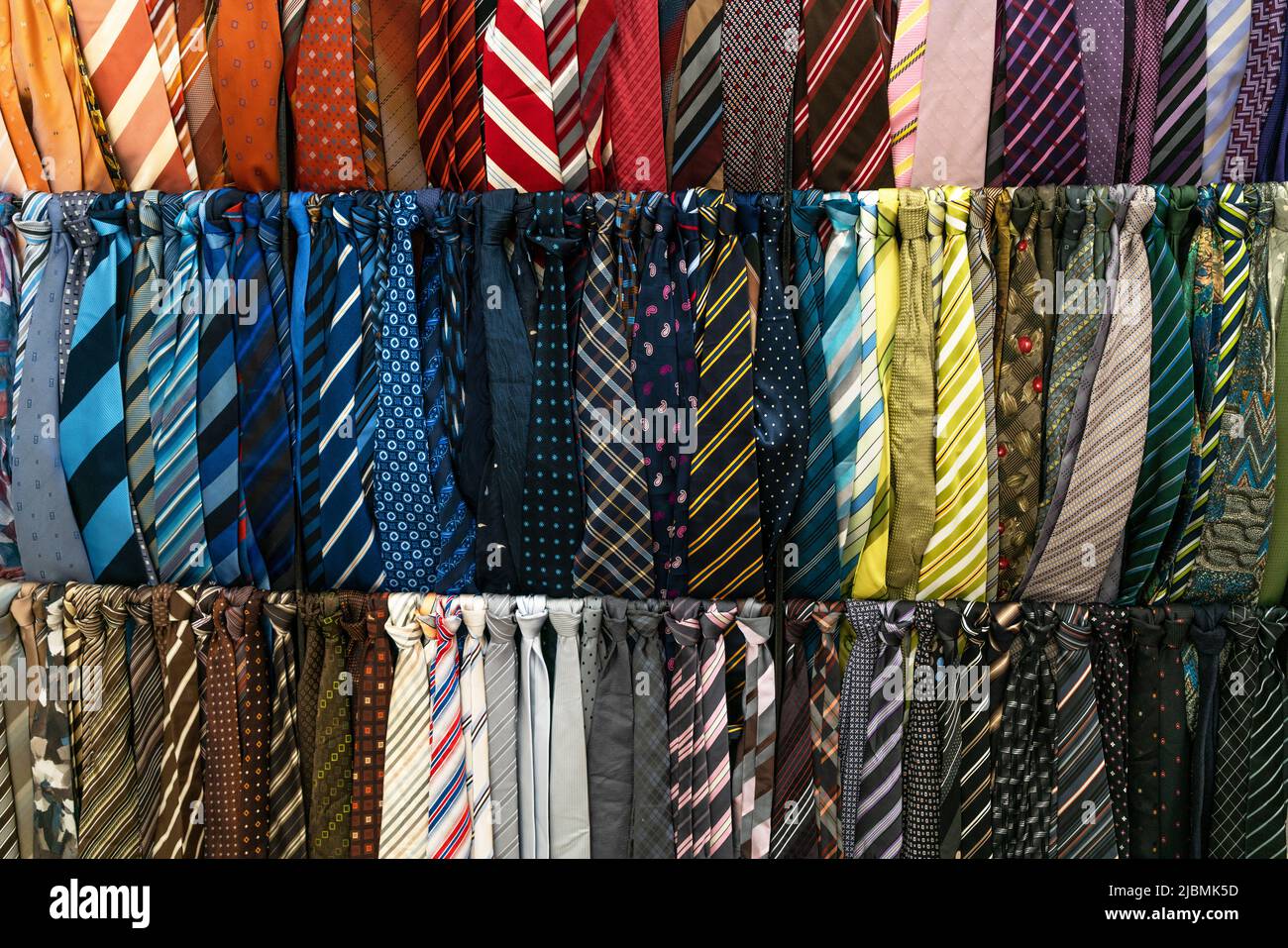 A selection of ties or neckties on display for sale in a mens fashion clothes shop or store Stock Photo