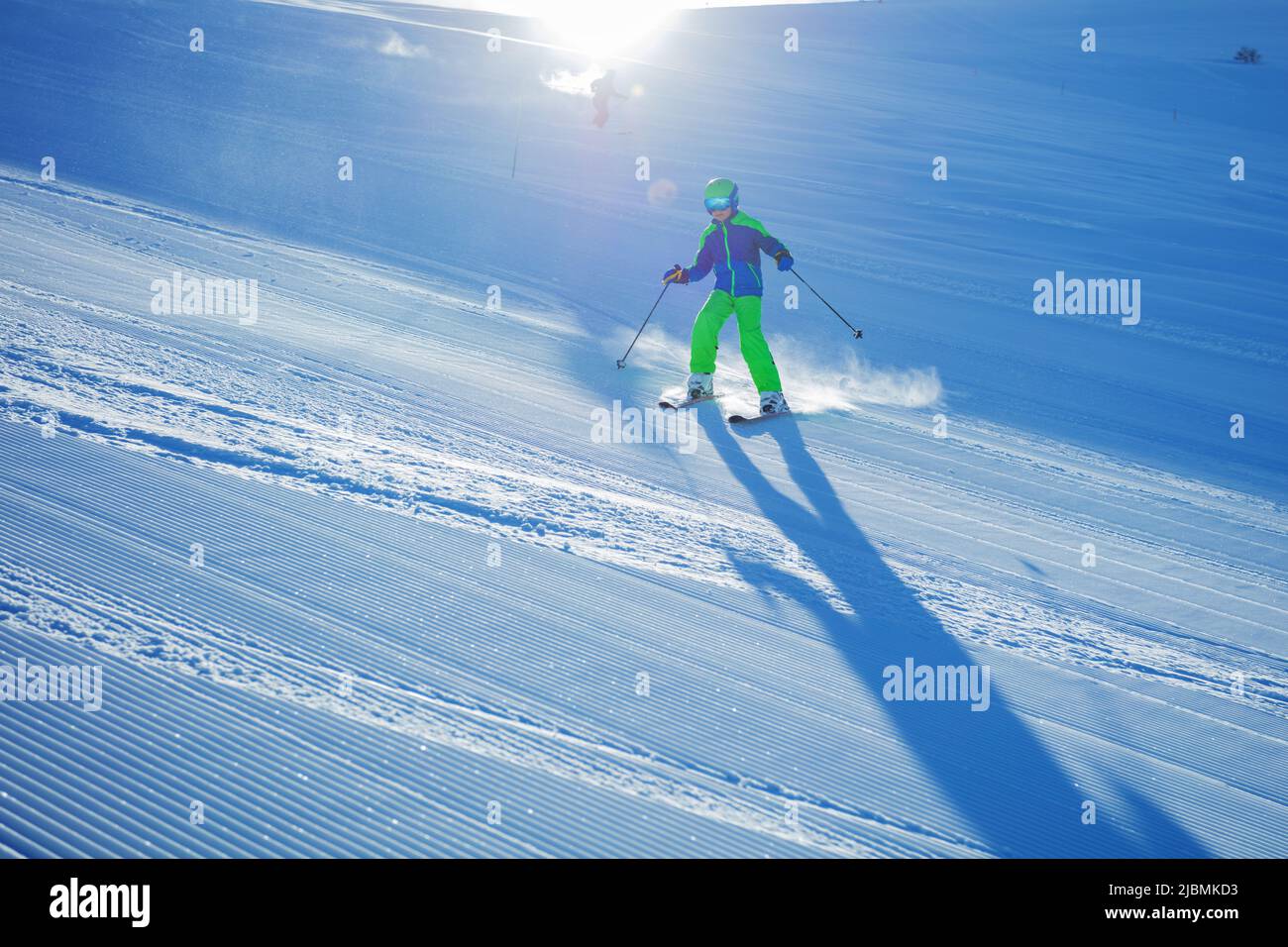 Action photo of a boy ski downhill fast on the fresh track Stock Photo