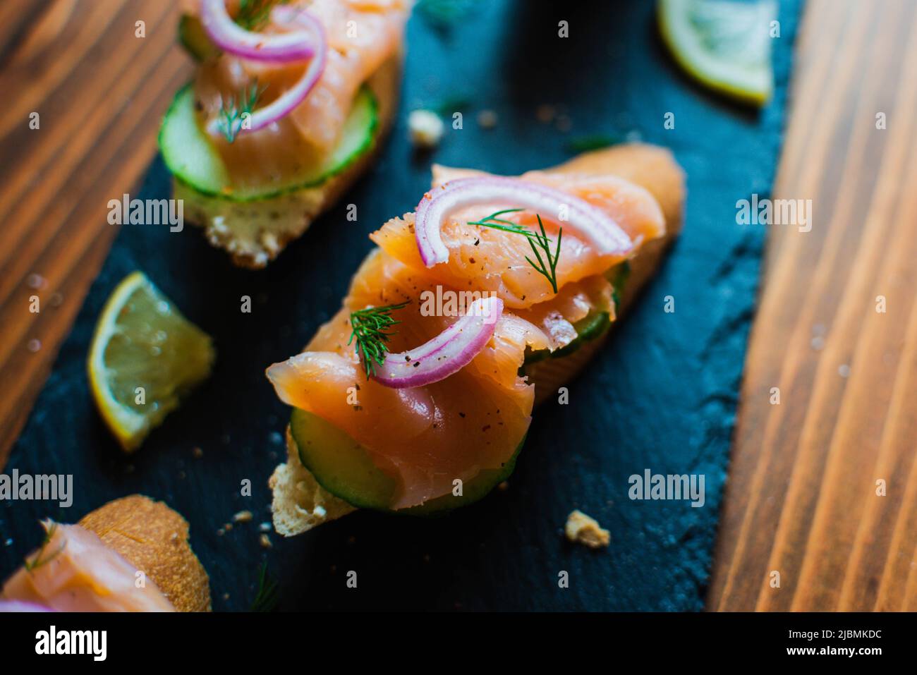 Closeup of smoked salmon on a baguette with cream cheese, cucumber