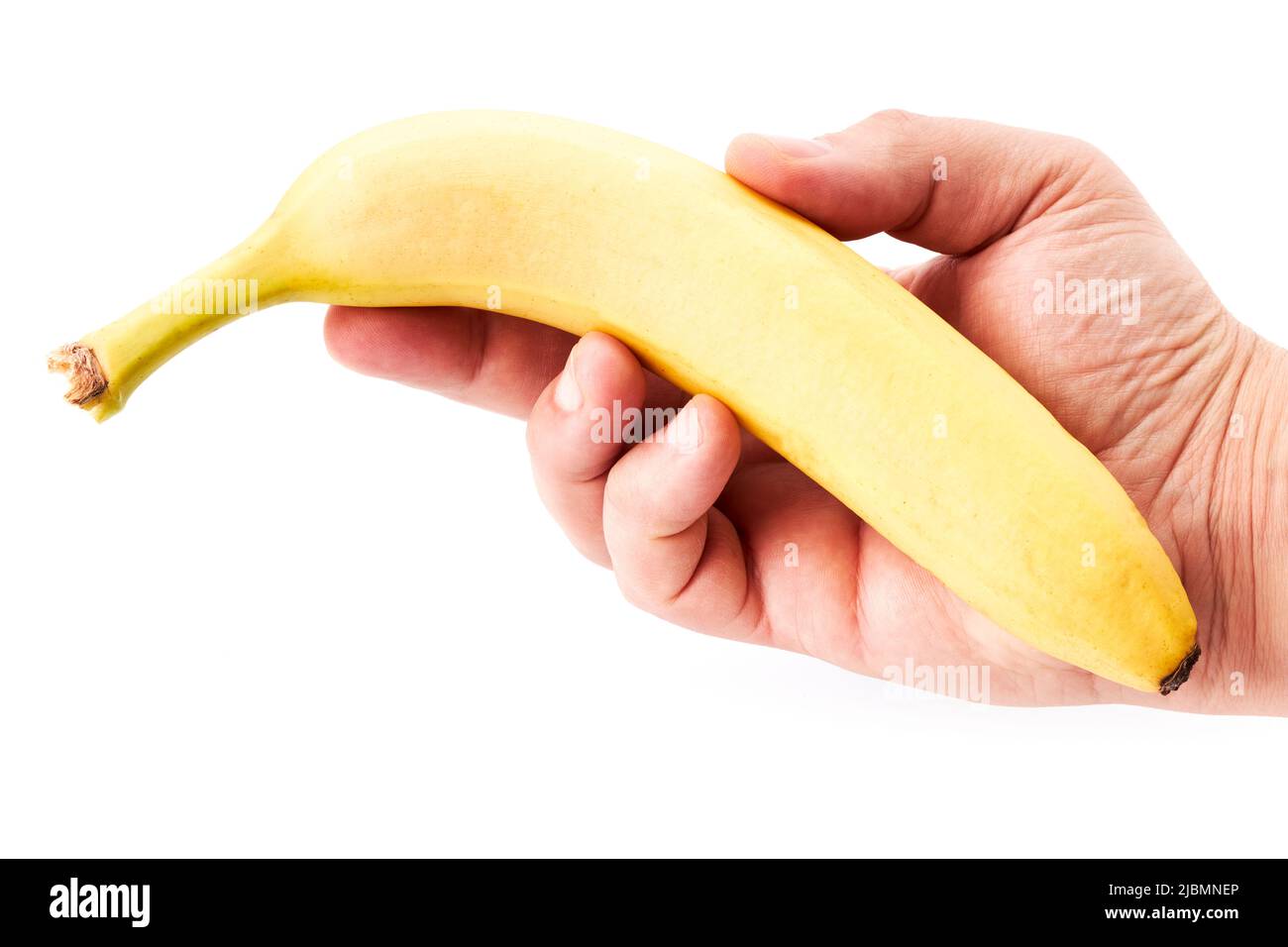 Hand of a man holding a ripe banana. Healthy food Stock Photo