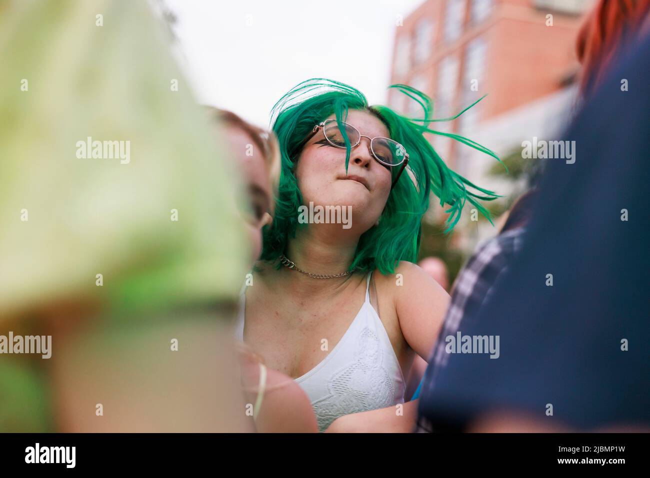 BLOOMINGTON, INDIANA - JUNE 4: An audience member dances as Car Seat Headrest performs during the Granfalloon festival on June 4, 2022, in Bloomington, Indiana. ÒGranfalloon is an annual festival of arts, music, and scholarship inspired by Hoosier author Kurt Vonnegut,Ó according to the eventÕs webpage. The festival takes place in Bloomington, Indiana. Stock Photo