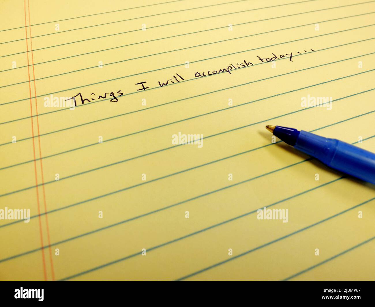 Note on paper things I will accomplish today written on notebook blue pen setting goals for self improvement Stock Photo