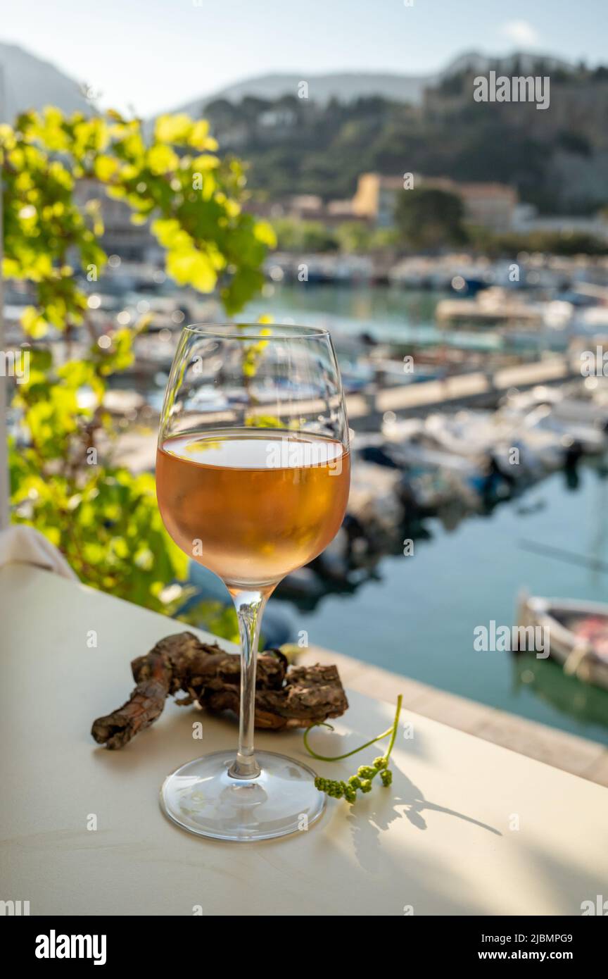Cold rose Provencal wine in glass served in sunlights on outdoor