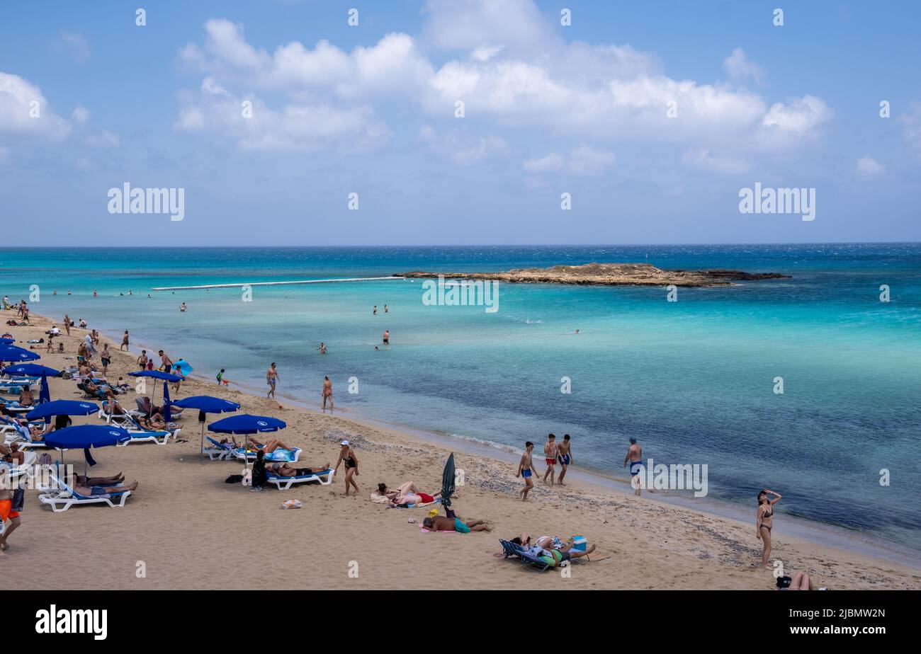 Tourist people enjoying summer vacations, relaxing, sunbathe swimming. Protaras fig tree bay Cyprus Stock Photo