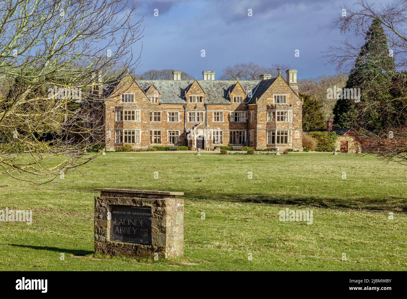 Front view of stone sign and Launde Abbey, Elizabethan manor house, in the Diocese of Leicester Stock Photo