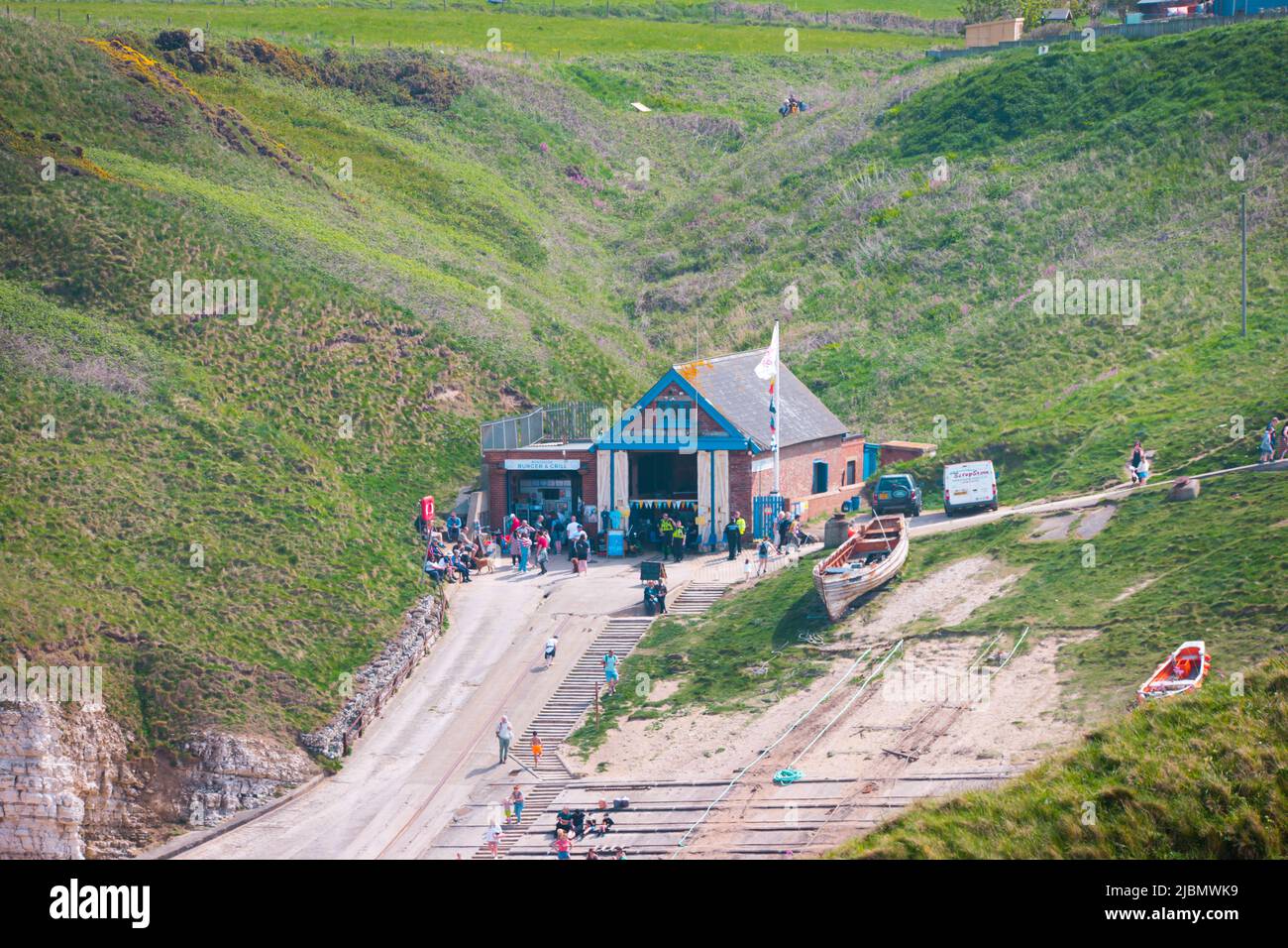 Landscape of the RNLI lifeboat house and cafe entrance at Flamborough North Landing on a sunny day Stock Photo