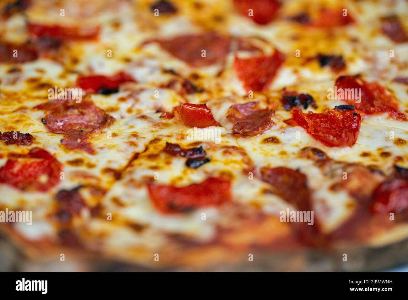 Pizza with mozzarella, and pepperoni, shot close up for use as a background. Stock Photo