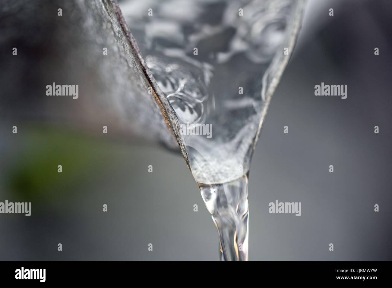 A flow of water from the spout of a water feature, shot close up in landscape format Stock Photo