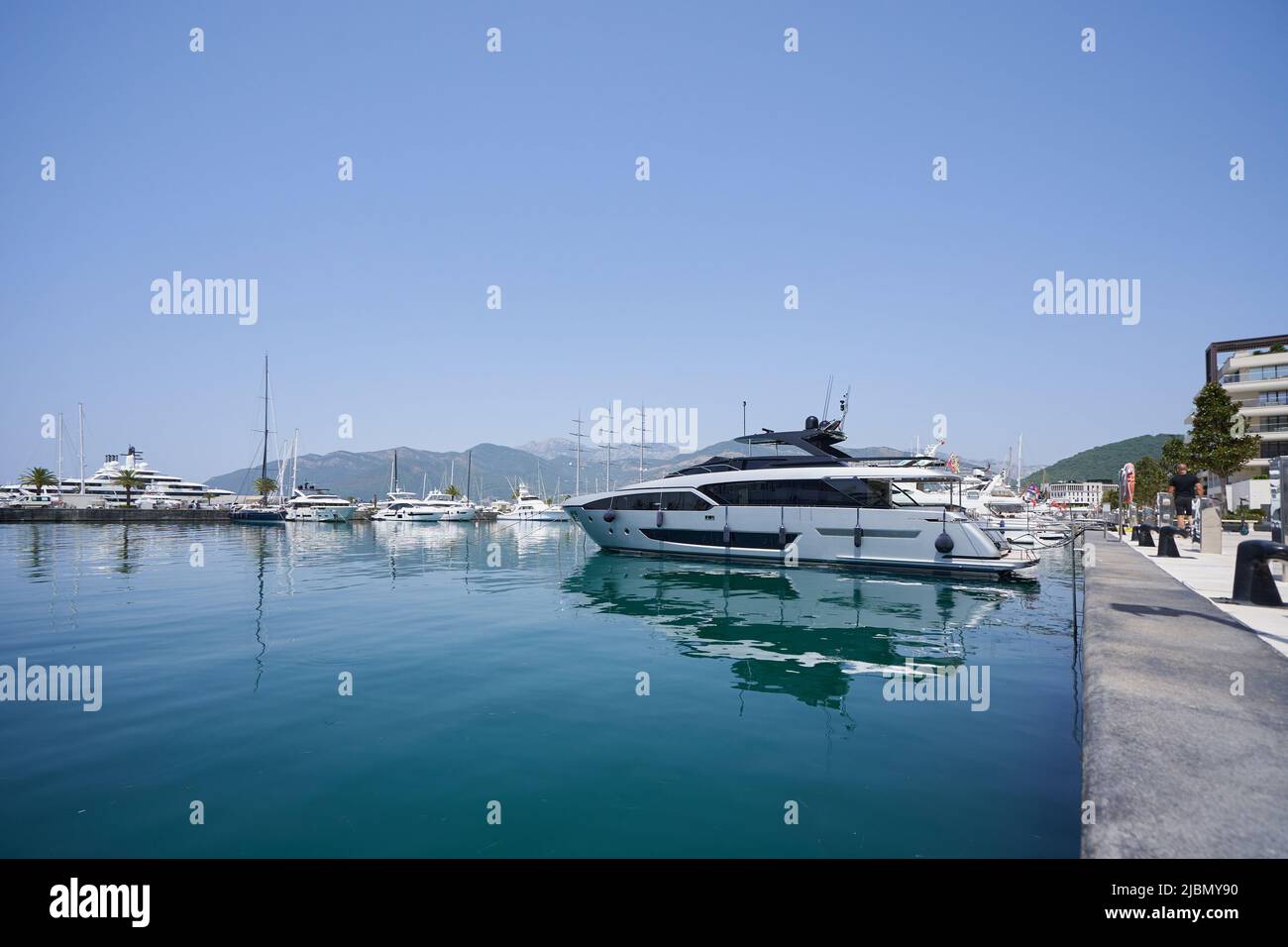 Gray luxury yacht moored in sea port. Stock Photo