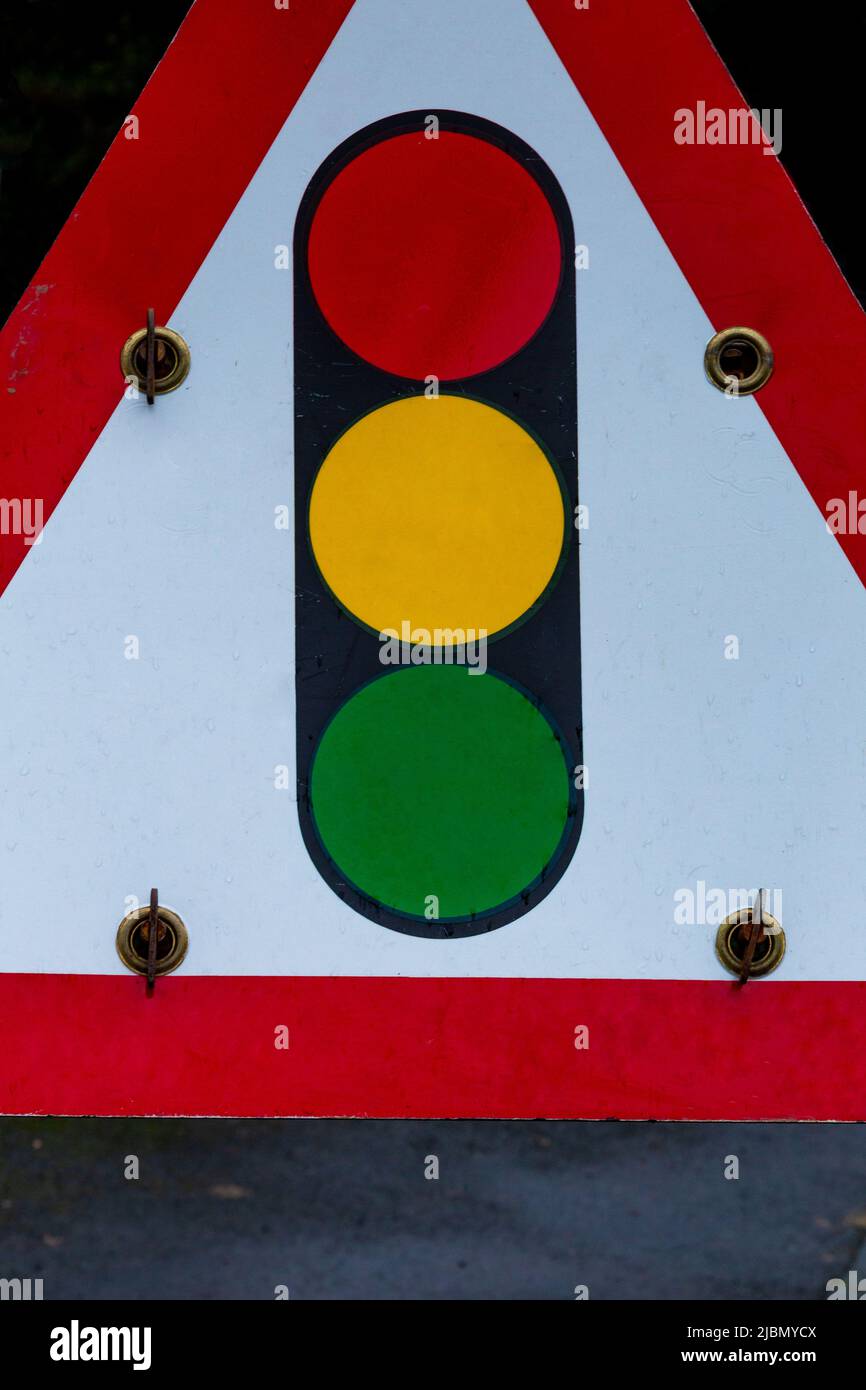 A temporary traffic light sign (UK) close up. Traffic signal ahead