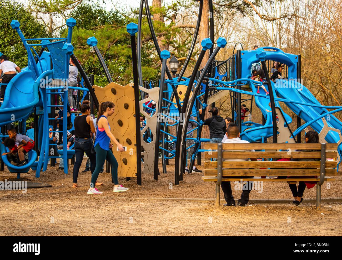 Kids having fun at Freedom Park in Charlotte, NC at an outdoor playground under the watchful eye of their parents or guardians. Stock Photo