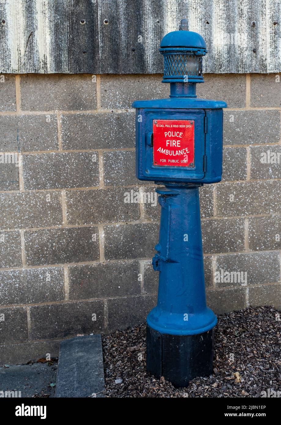 Old style police, fire and ambulance call box, blue with red signage. Stock Photo