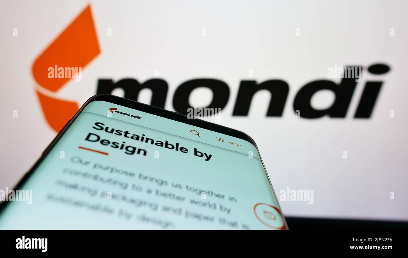 Mobile phone with website of packaging company Mondi plc on screen in